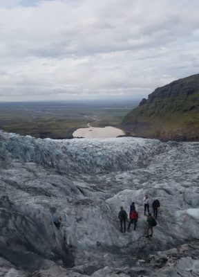 A group reached their ending point during their glacier tour, overlooking the glacier, glacier lagoon and vast sand plains.